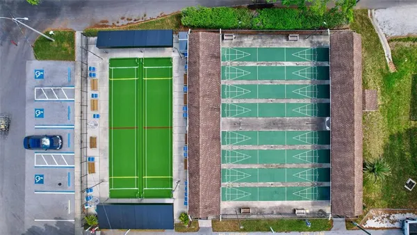 an aerial view of a house with garden space and street view