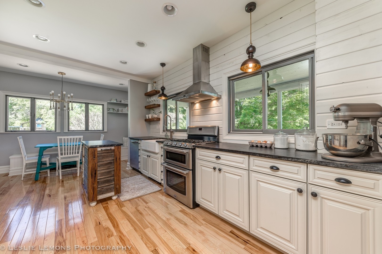 32-w028 Army Trail Road Wayne, IL 60184 - Photo 11 of 39 a kitchen with stainless steel appliances a stove a sink dishwasher and white cabinets with wooden floor