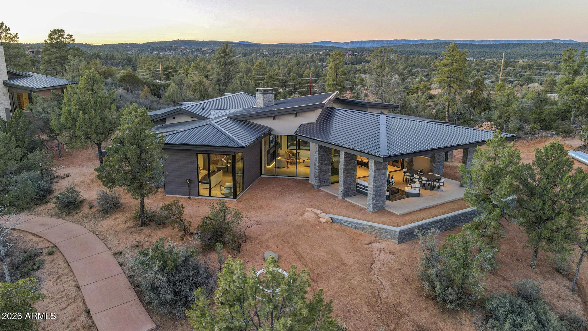 108 South Rim Club Drive Payson, AZ 85541 - Photo 4 of 56 a aerial view of a house with table and chairs under an umbrella