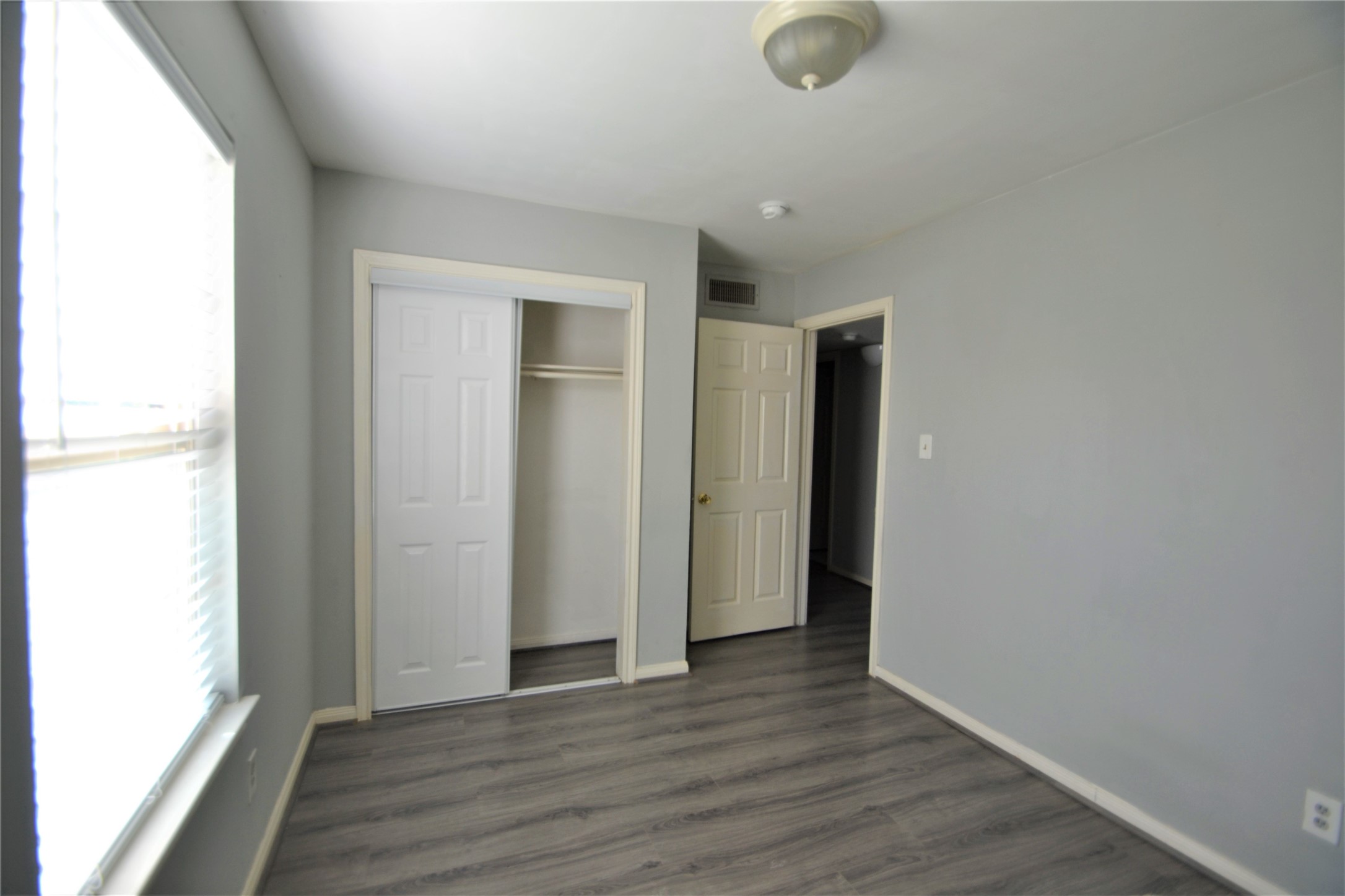 304 Dell Court, Unit 7 Houston, TX 77009 - Photo 27 of 36 a view of an empty room with wooden floor