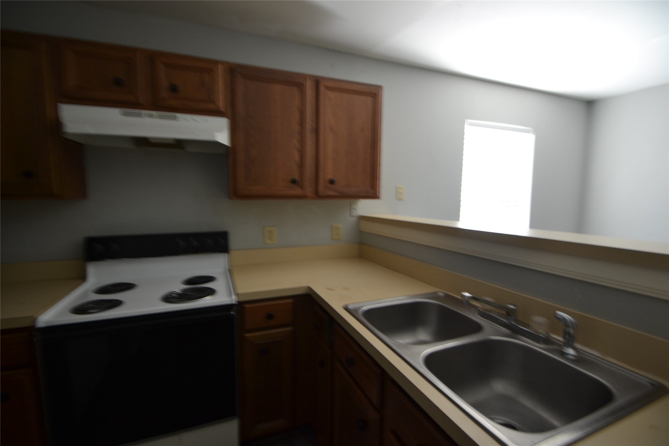 304 Dell Court, Unit 7 Houston, TX 77009 - Photo 29 of 36 a kitchen with a sink a stove and cabinets