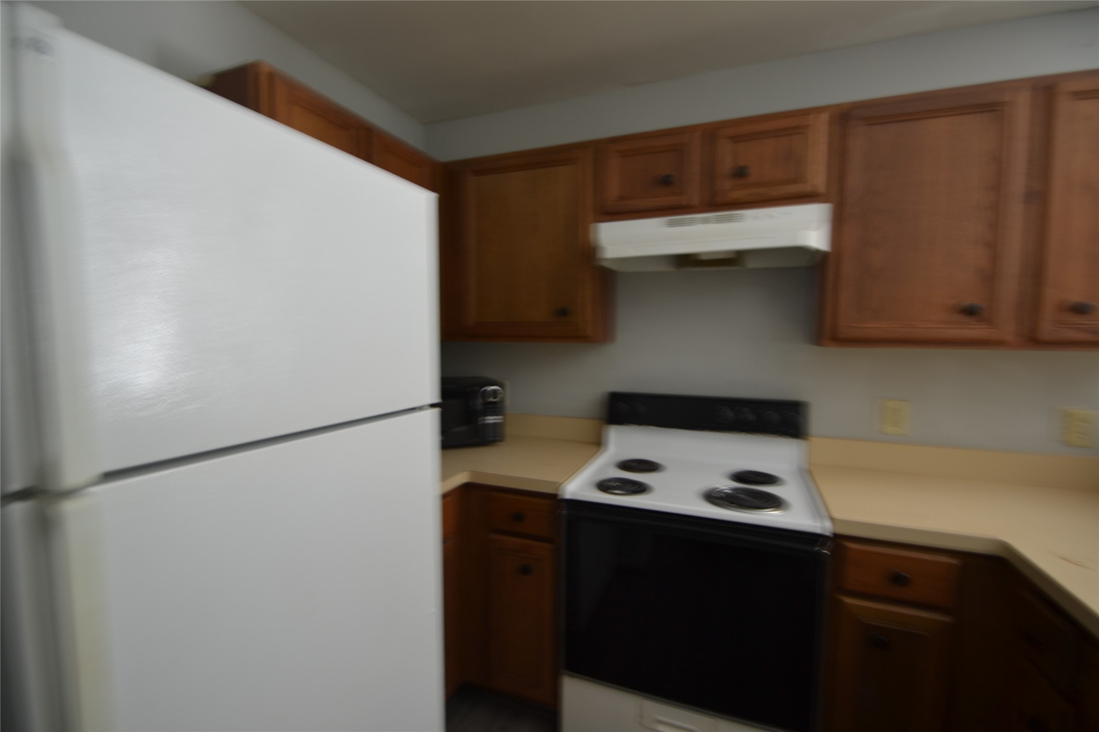 304 Dell Court, Unit 7 Houston, TX 77009 - Photo 30 of 36 a white refrigerator freezer sitting inside of a kitchen