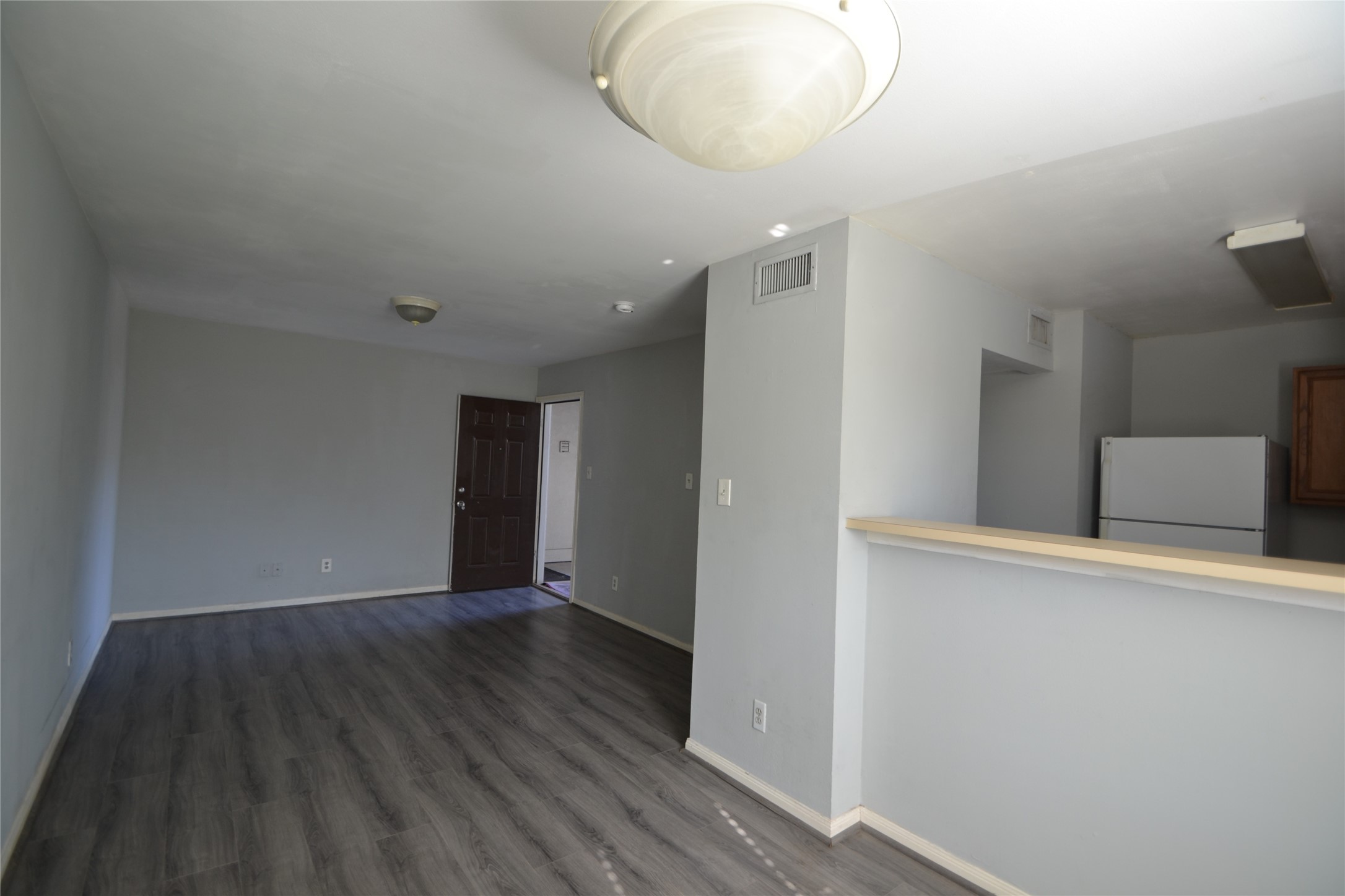 304 Dell Court, Unit 7 Houston, TX 77009 - Photo 32 of 36 wooden floor in an empty room with a window