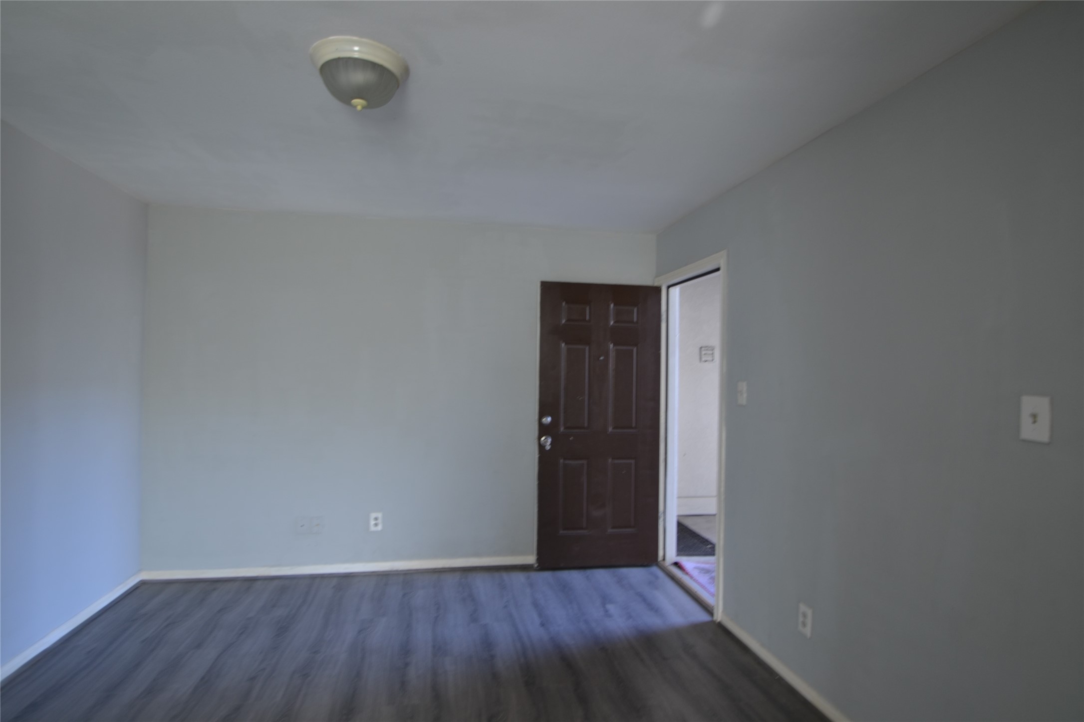 304 Dell Court, Unit 7 Houston, TX 77009 - Photo 34 of 36 a view of an empty room with wooden floor and a window