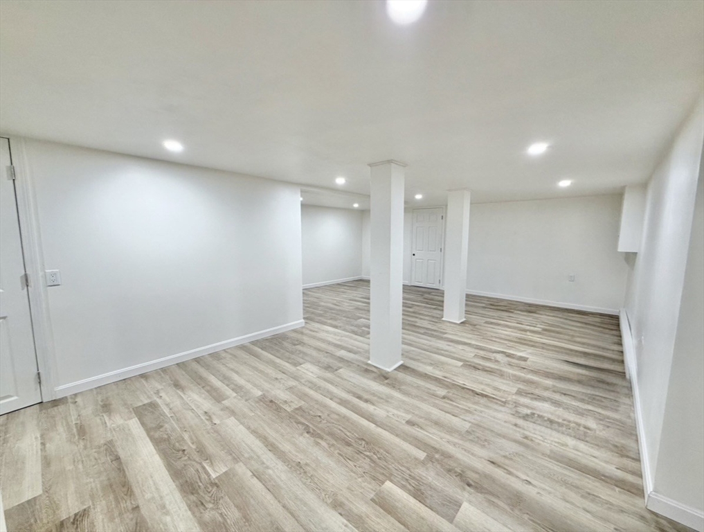 9 Robbins Street Waltham, MA 02453 - Photo 31 of 42 a view of an empty room with wooden floor