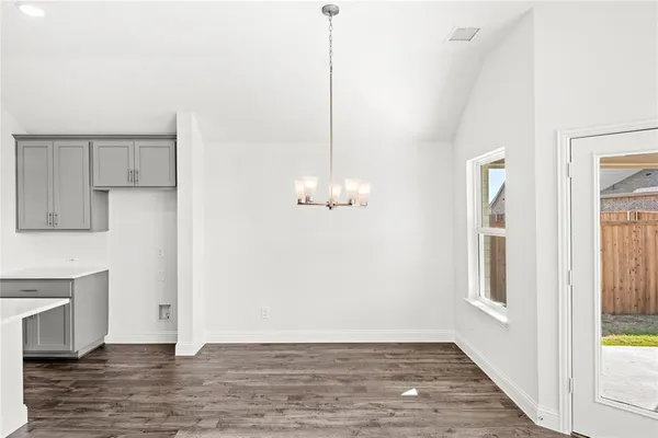 a view of a room with wooden floor and chandelier
