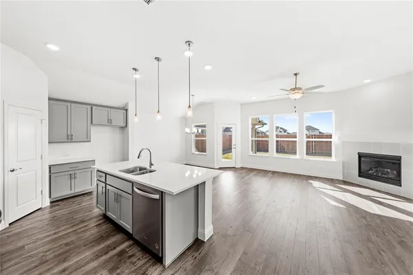 a kitchen with stainless steel appliances granite countertop a sink stove and wooden floor