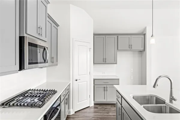 a kitchen with stainless steel appliances granite countertop a sink stove and cabinets
