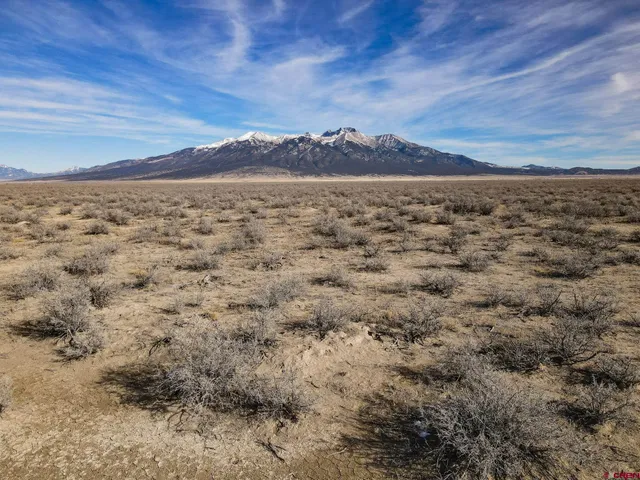 a view of an ocean beach and mountain
