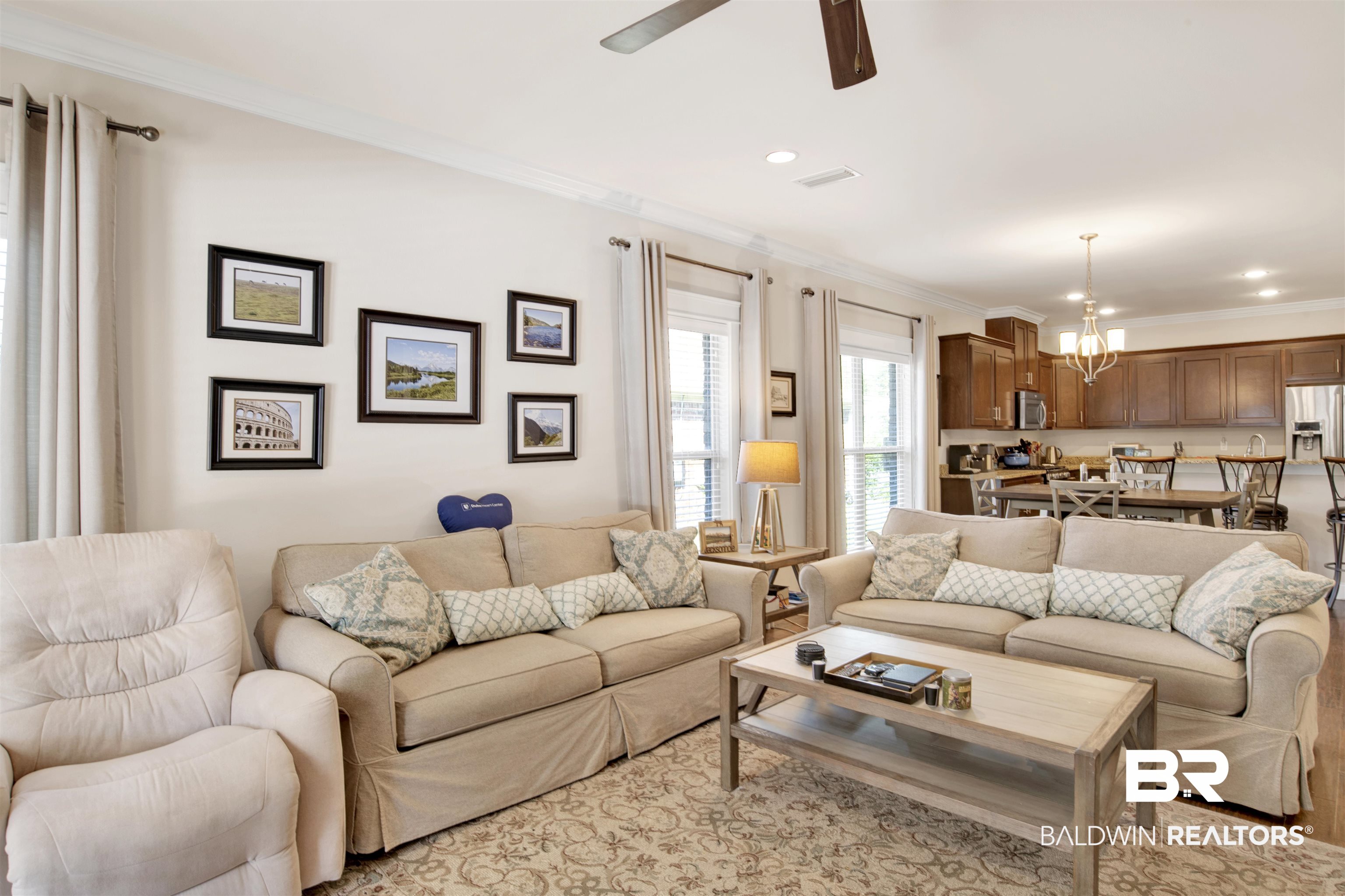 360 Scarlett Avenue Fairhope, AL 36532 - Photo 21 of 34 Living room with ceiling fan with notable chandelier and crown molding
