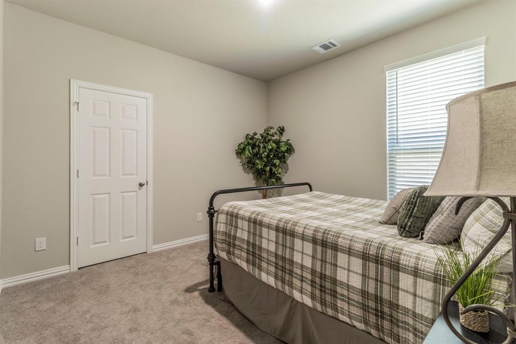 626 Ruthye Lane Pilot Point, TX 76258 - Photo 12 of 28 Bedroom with light carpet and baseboards