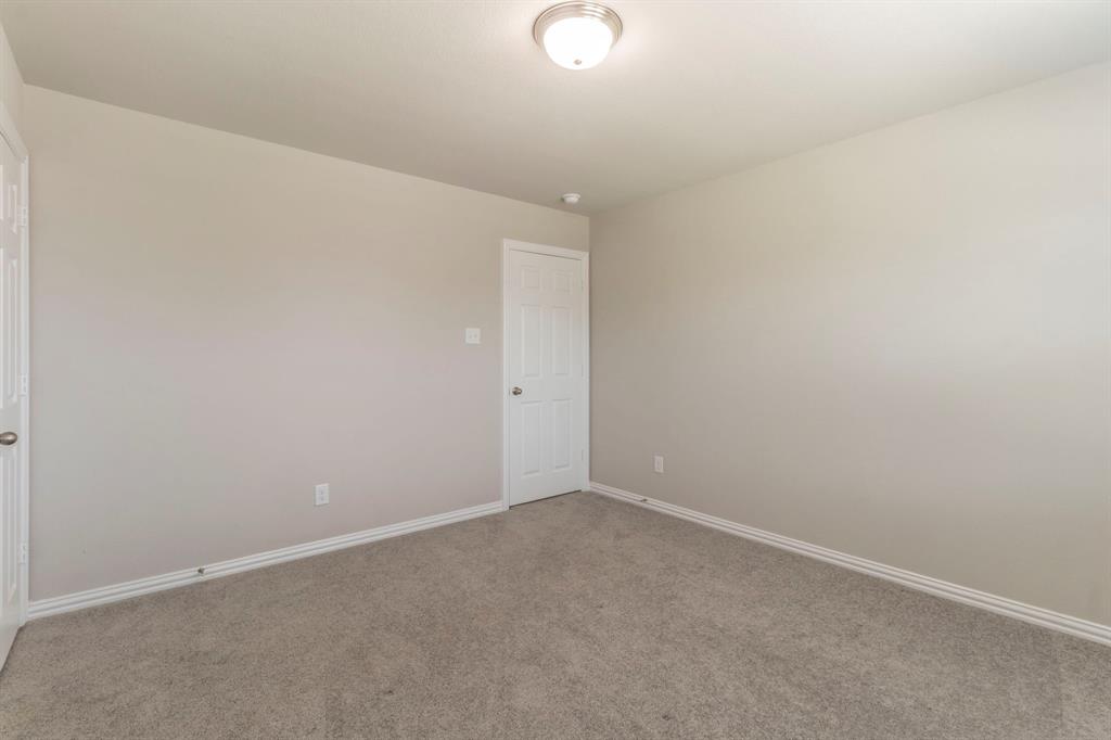 626 Ruthye Lane Pilot Point, TX 76258 - Photo 18 of 28 Empty room with carpet and baseboards