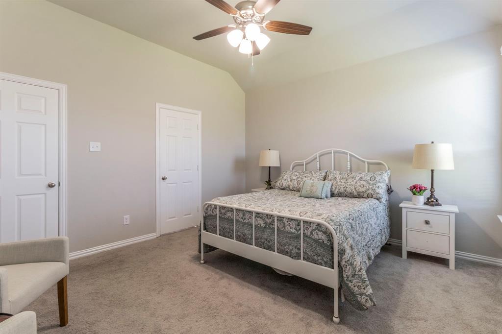 626 Ruthye Lane Pilot Point, TX 76258 - Photo 5 of 28 Bedroom with vaulted ceiling, light colored carpet, and a ceiling fan
