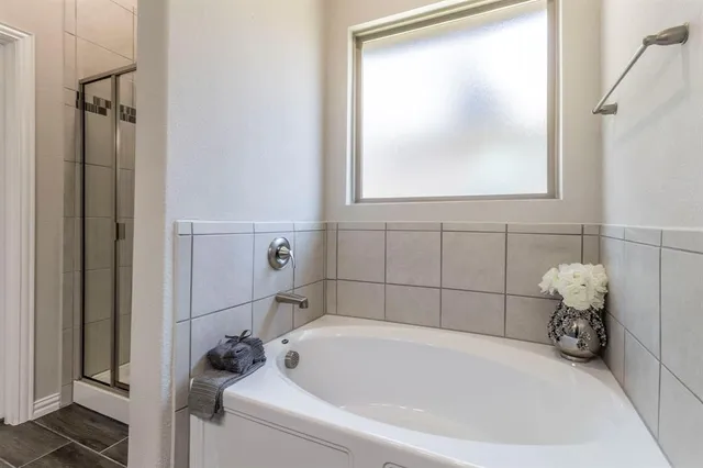 a bathroom with a tub and a window