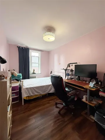 a bedroom with a bed and a desk