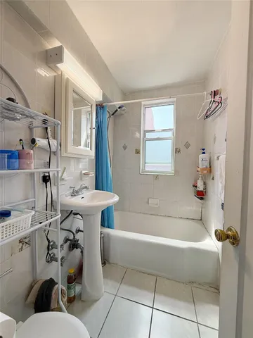 a bathroom with a sink mirror toilet and bathtub