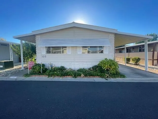 a front view of a house with a yard and a garage
