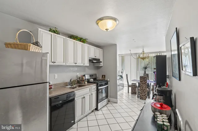 a kitchen with sink cabinets and appliances