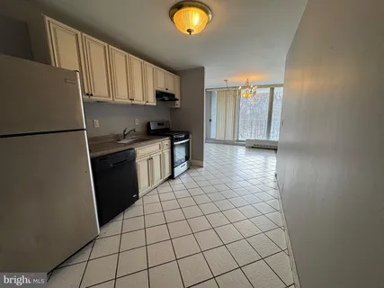a kitchen with a sink a stove and refrigerator