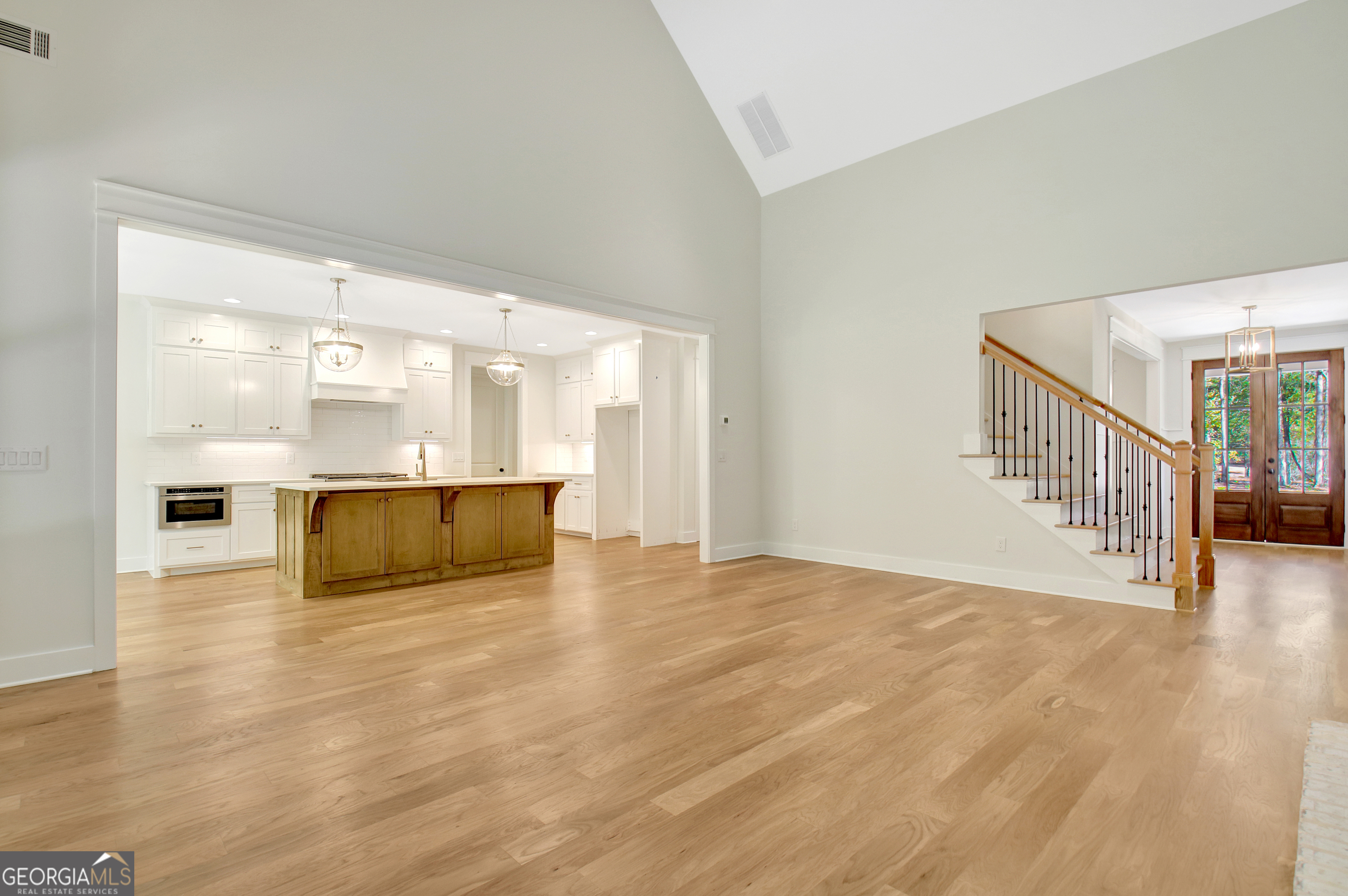 196 Bob Smith Road Sharpsburg, GA 30277 - Photo 13 of 68 a view of an empty room with wooden floor and a window