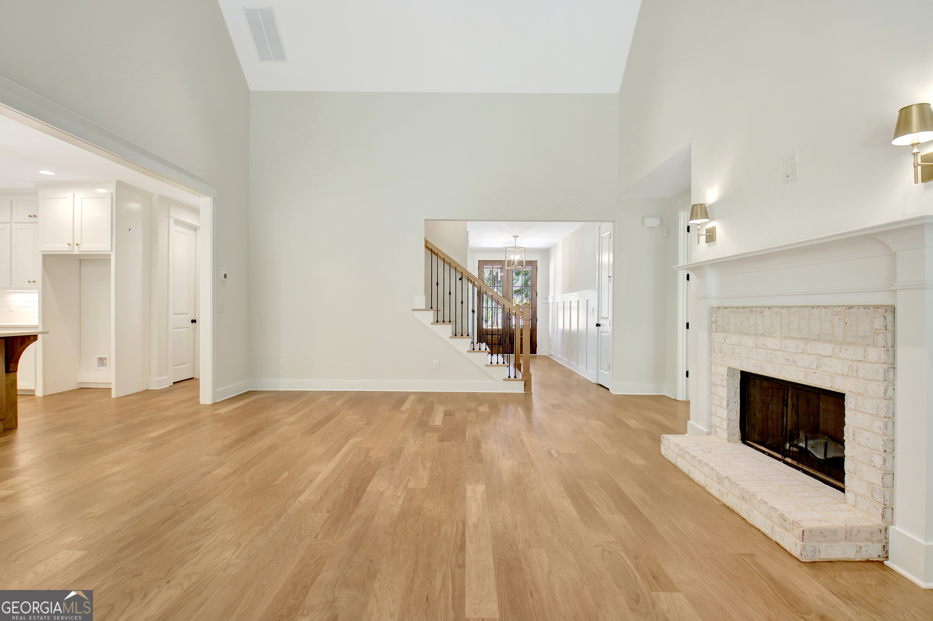 196 Bob Smith Road Sharpsburg, GA 30277 - Photo 14 of 68 a view of empty room with wooden floor and fireplace