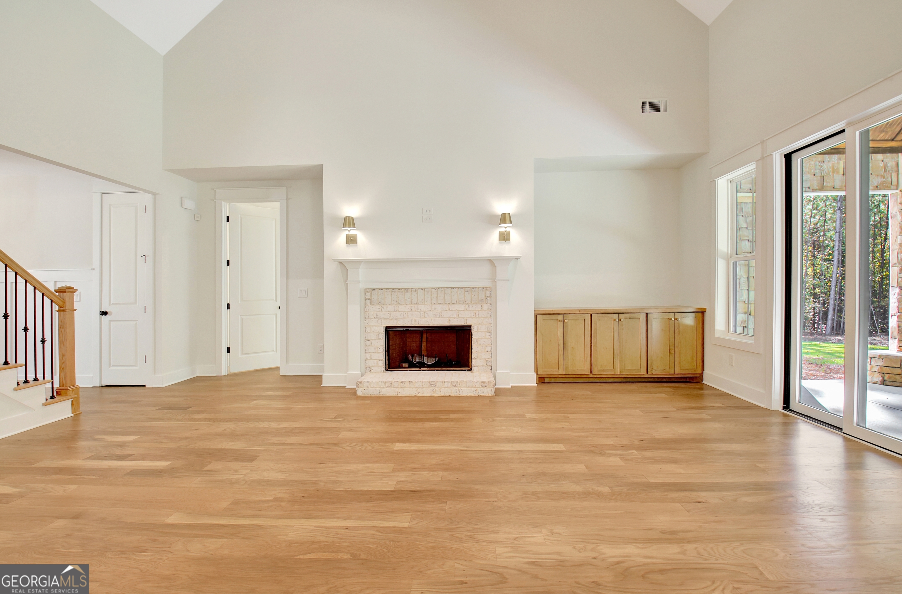 196 Bob Smith Road Sharpsburg, GA 30277 - Photo 15 of 68 a view of an empty room with wooden floor and a fireplace