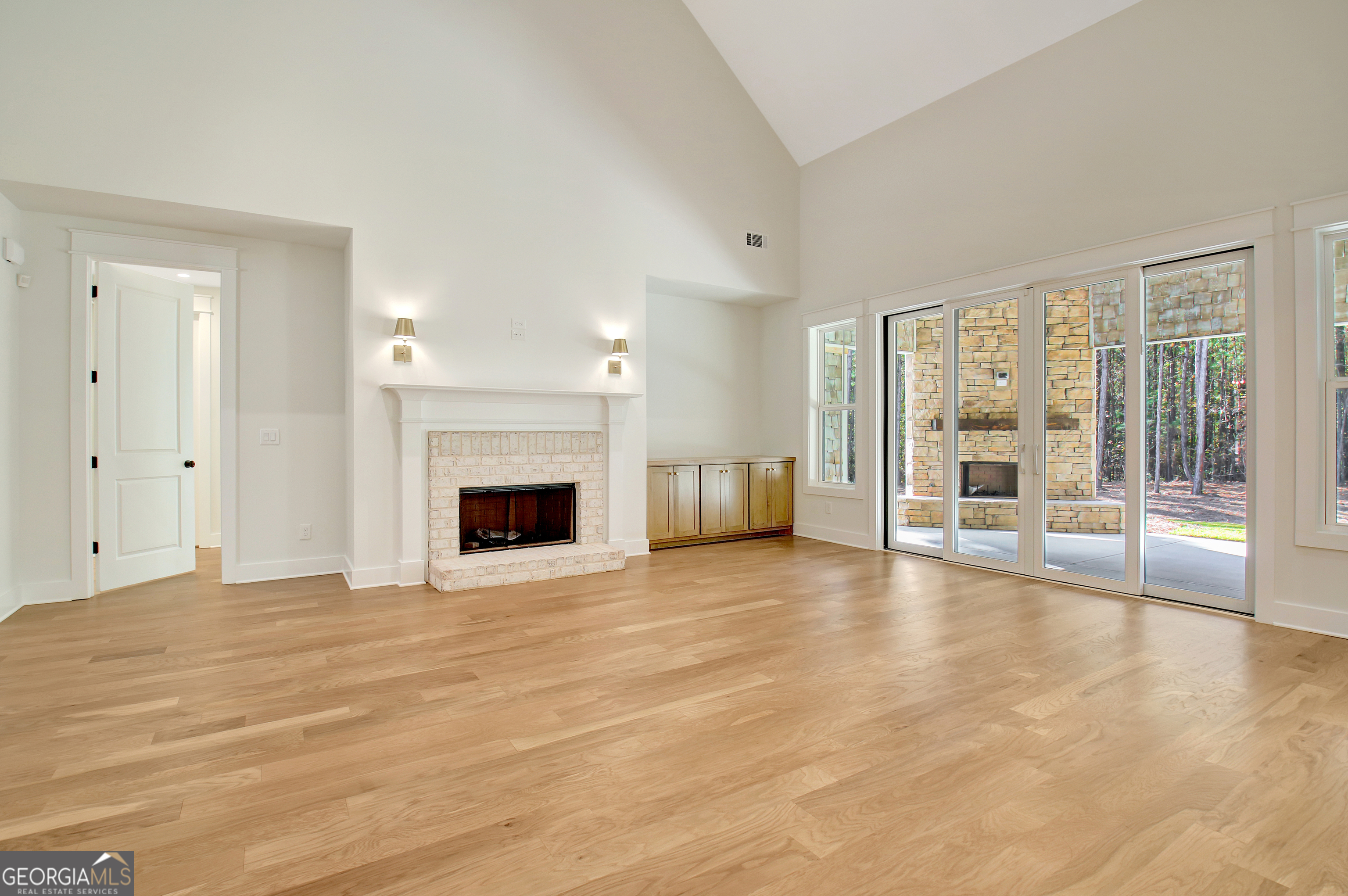 196 Bob Smith Road Sharpsburg, GA 30277 - Photo 16 of 68 a view of an empty room with a fireplace and a window