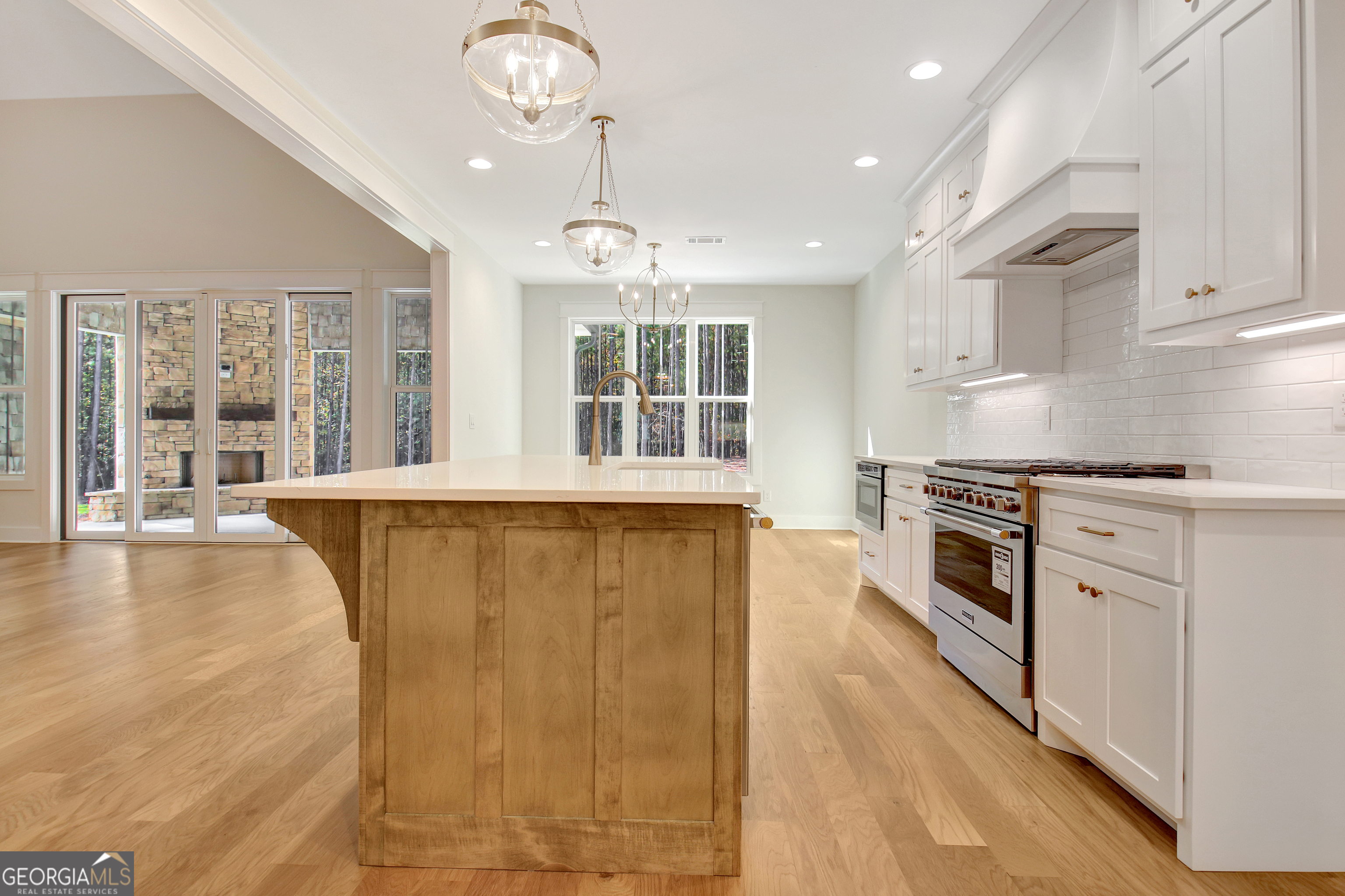 196 Bob Smith Road Sharpsburg, GA 30277 - Photo 22 of 68 a large kitchen with stainless steel appliances granite countertop a stove and a refrigerator