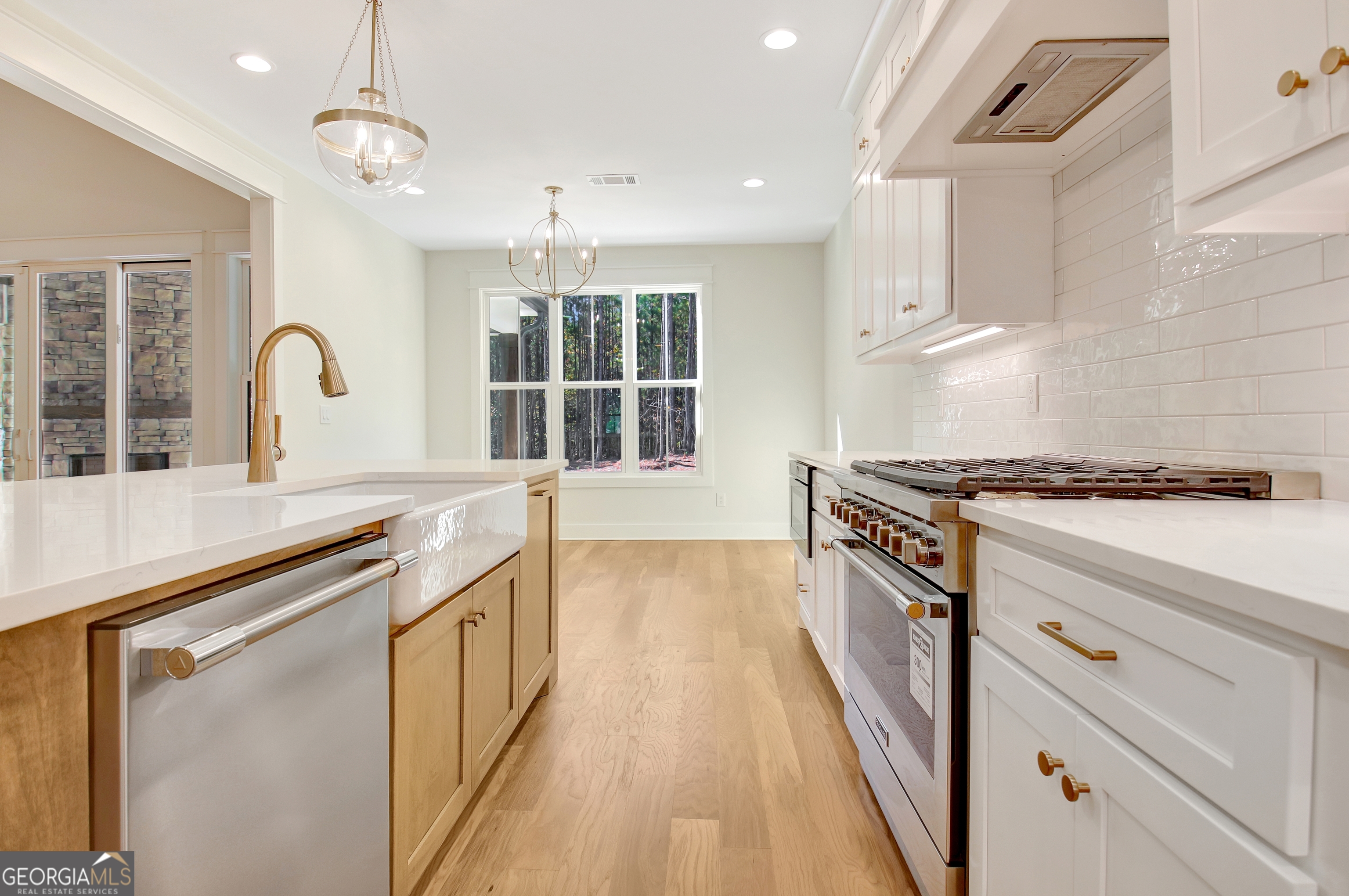 196 Bob Smith Road Sharpsburg, GA 30277 - Photo 24 of 68 a kitchen with stainless steel appliances granite countertop a stove and a sink