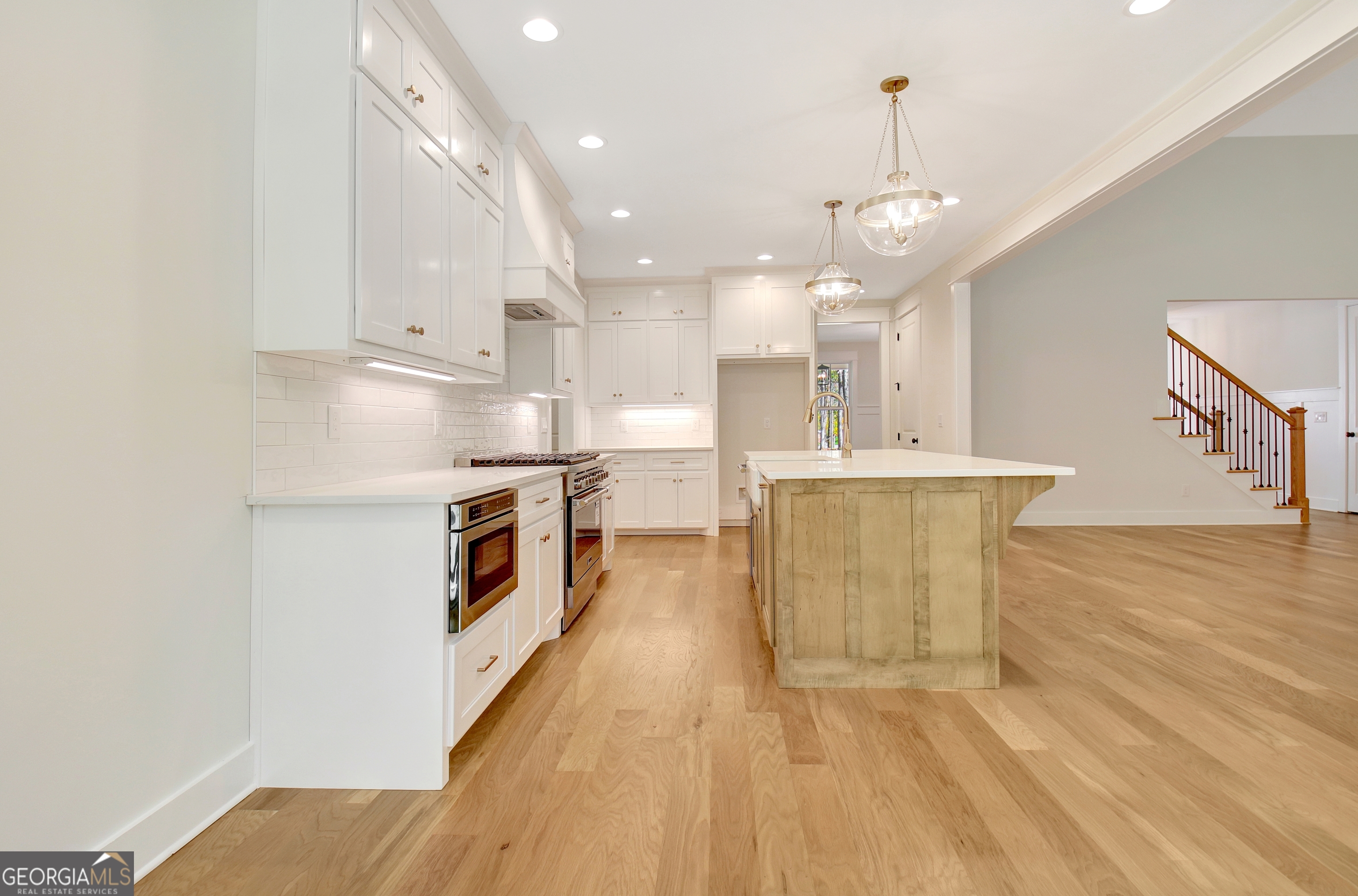 196 Bob Smith Road Sharpsburg, GA 30277 - Photo 26 of 68 a kitchen with stainless steel appliances granite countertop a sink a stove and a refrigerator