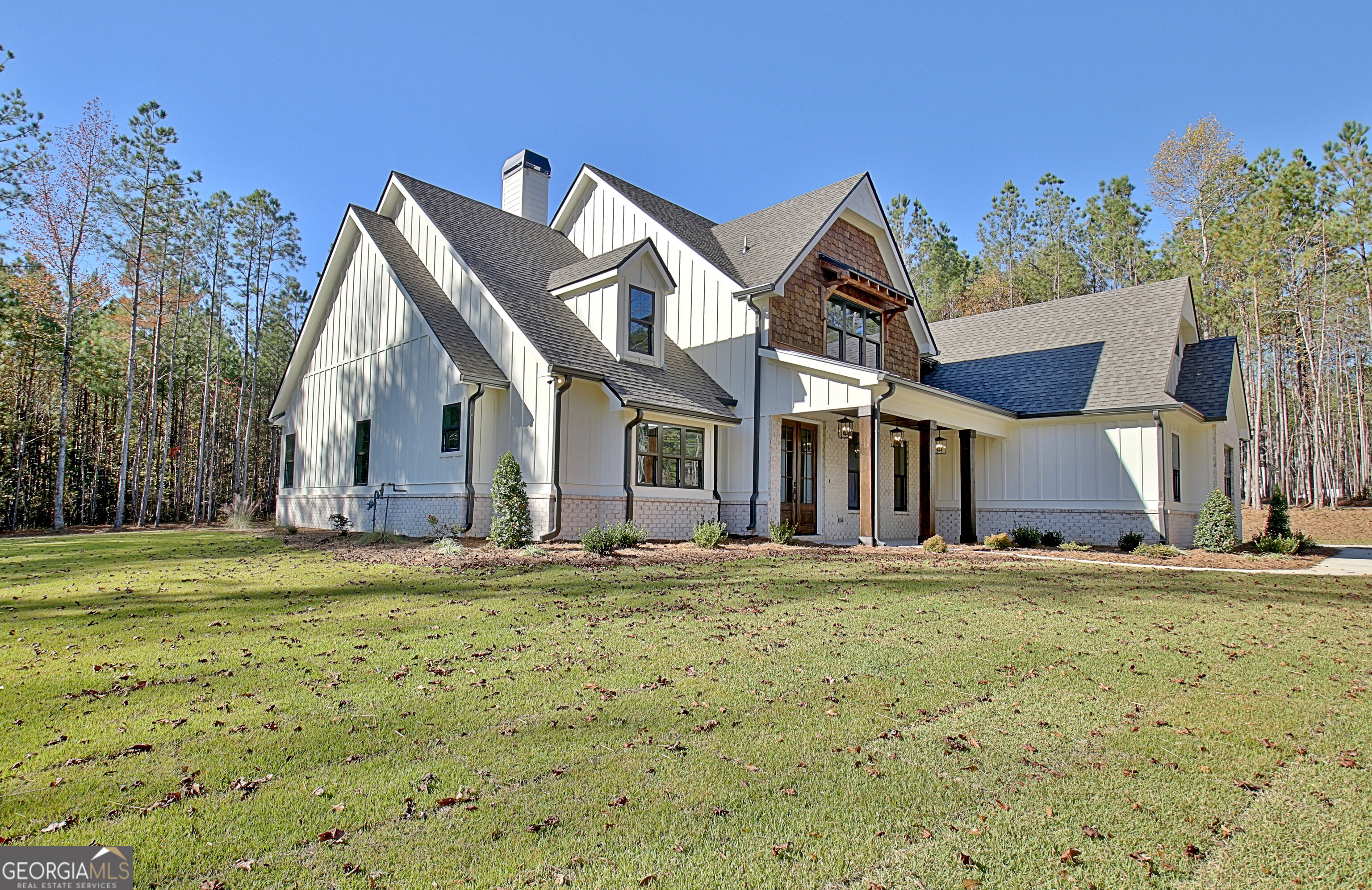 196 Bob Smith Road Sharpsburg, GA 30277 - Photo 3 of 68 a big house with a big yard and large trees
