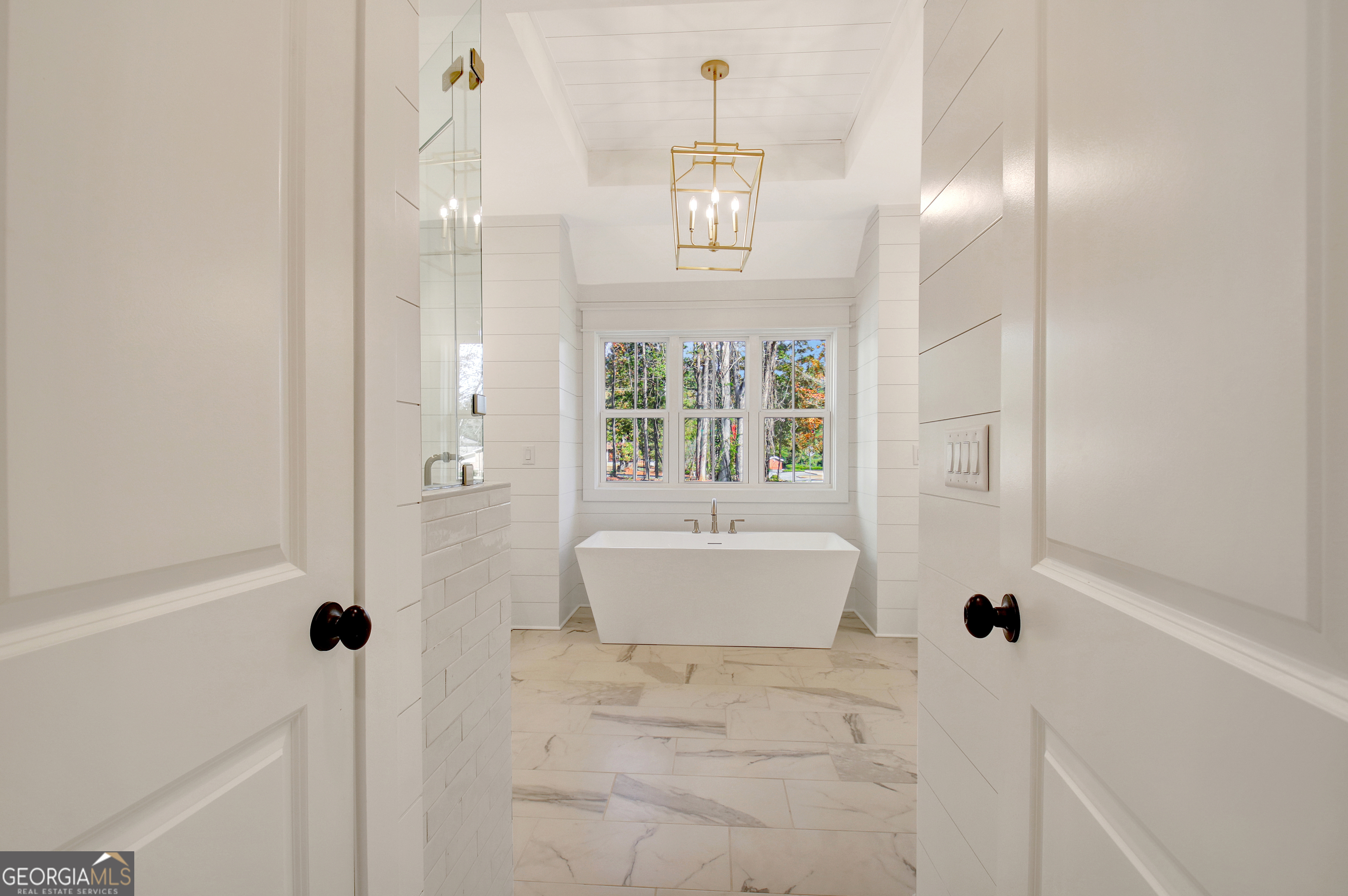 196 Bob Smith Road Sharpsburg, GA 30277 - Photo 37 of 68 a bathroom with a tub shower and window