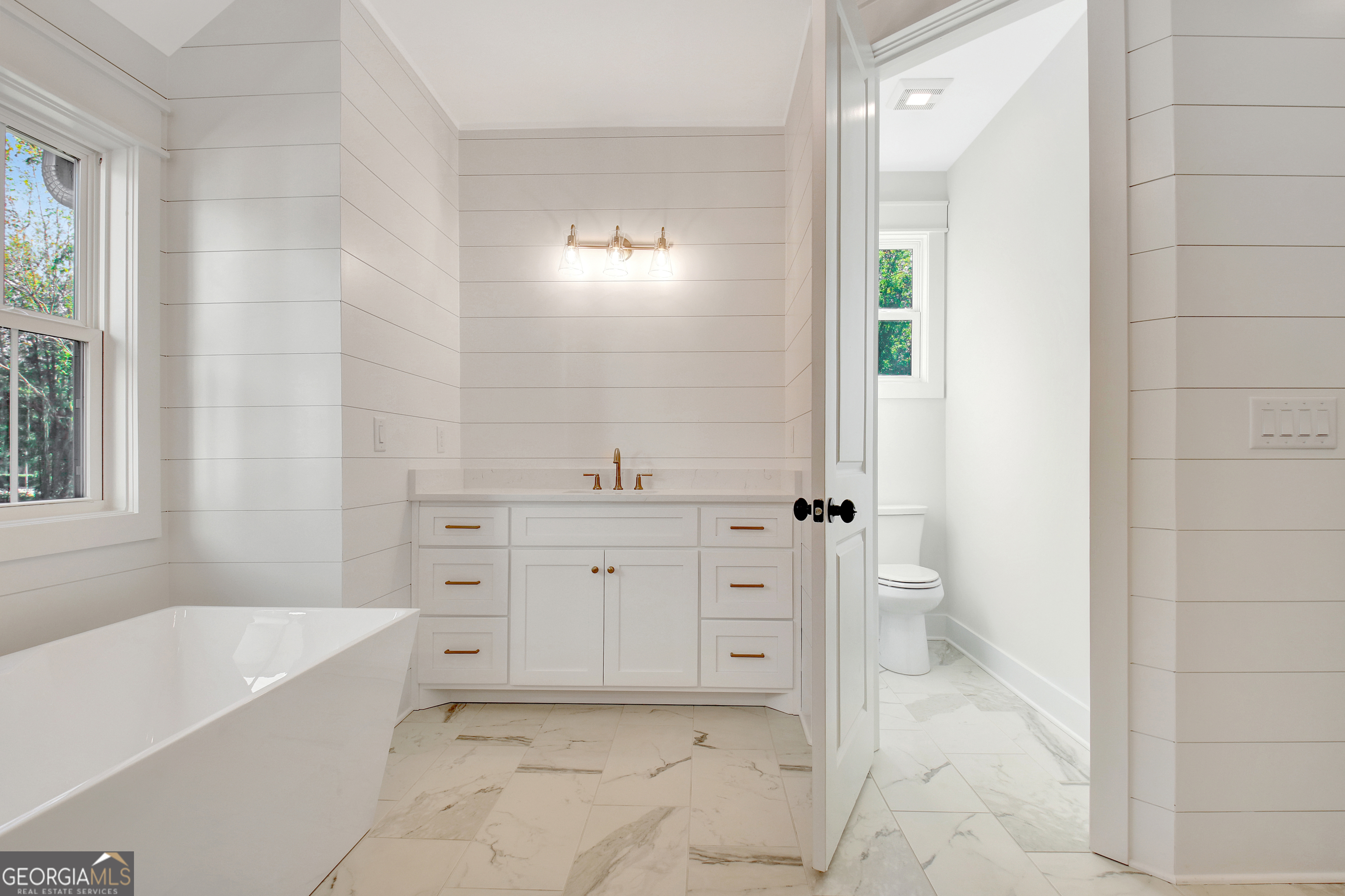 196 Bob Smith Road Sharpsburg, GA 30277 - Photo 39 of 68 a spacious bathroom with a bathtub sink and toilet