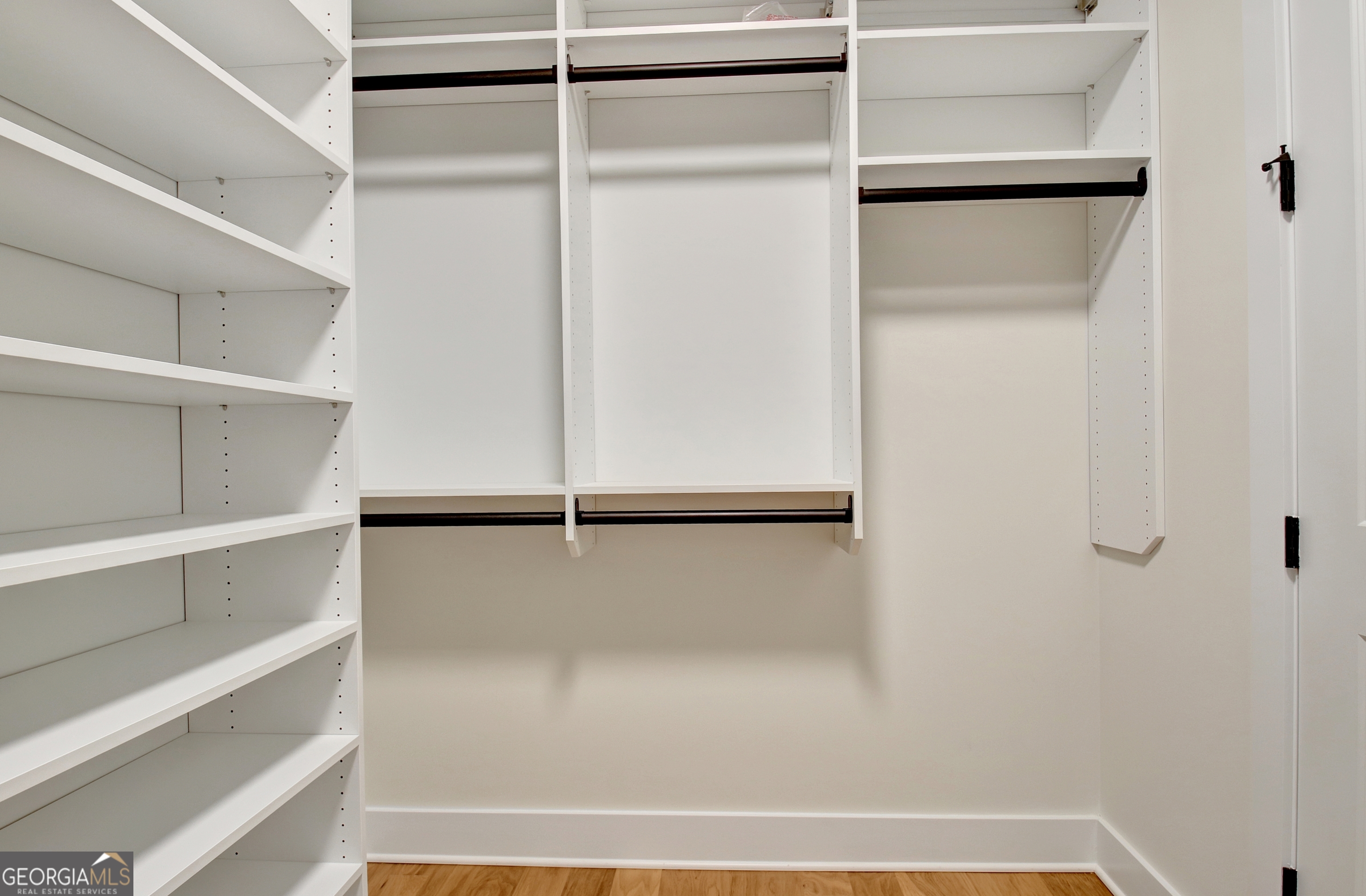 196 Bob Smith Road Sharpsburg, GA 30277 - Photo 43 of 68 a view of walk in closet with empty racks