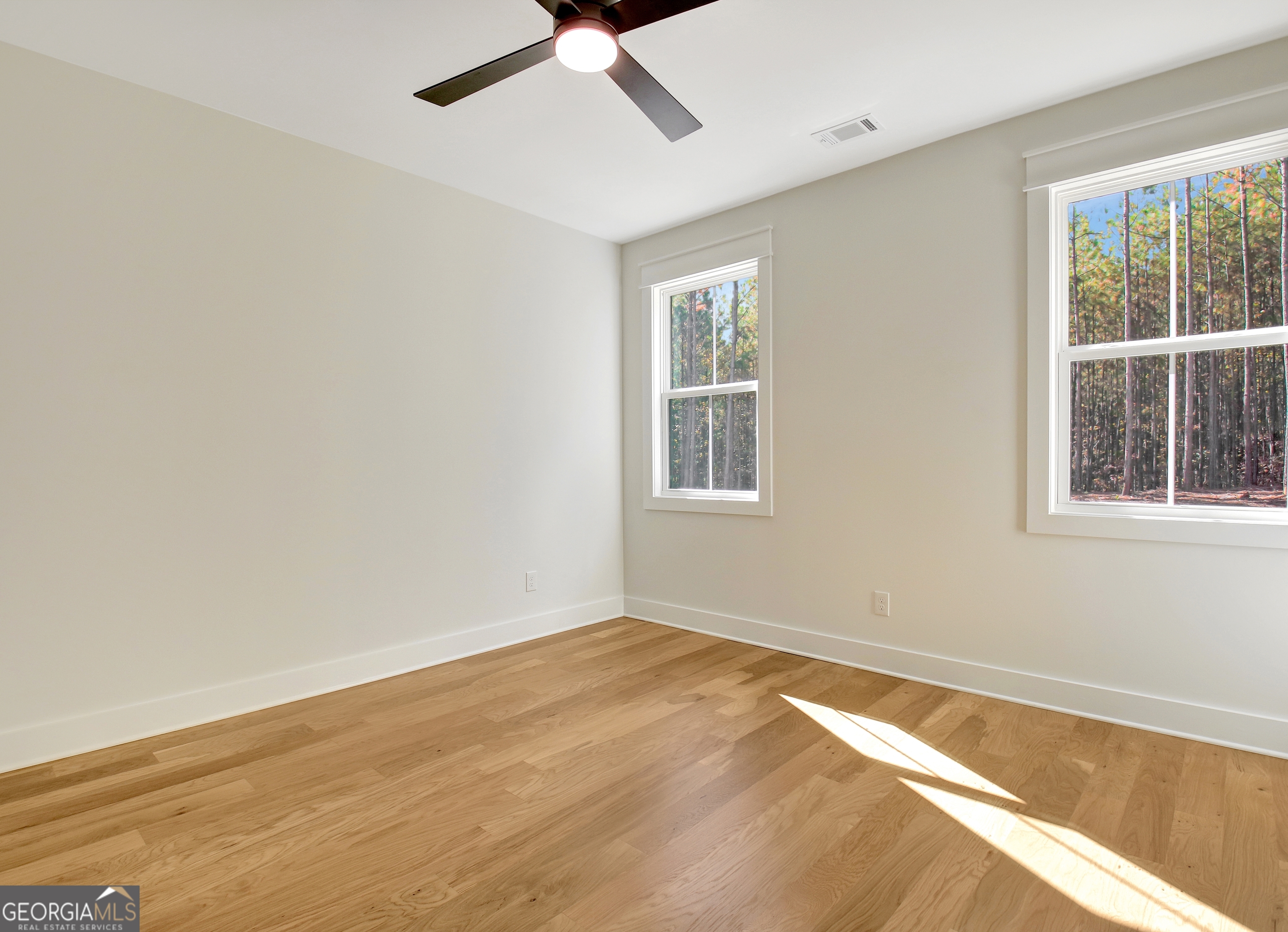 196 Bob Smith Road Sharpsburg, GA 30277 - Photo 46 of 68 wooden floor in an empty room with a window