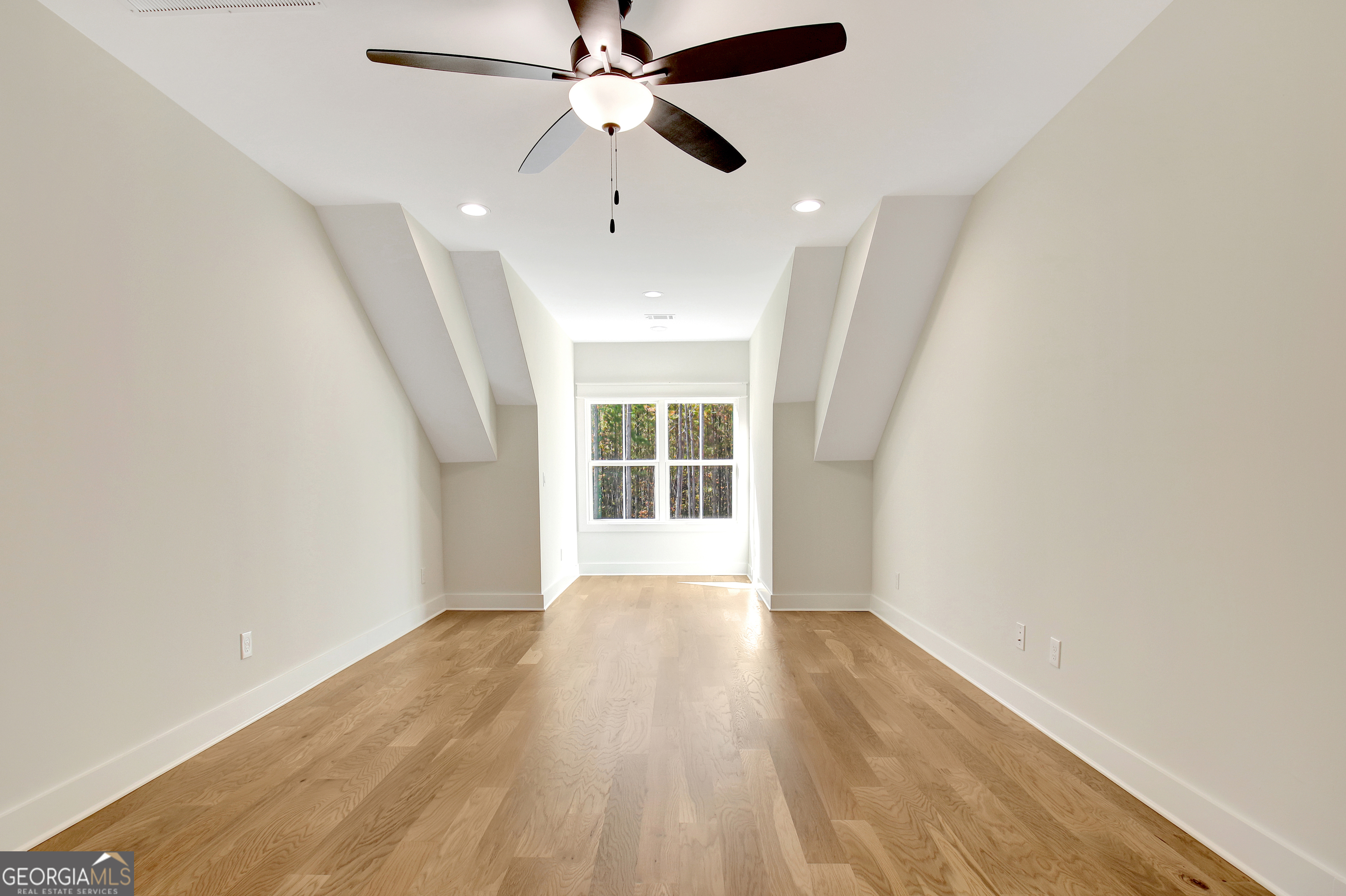 196 Bob Smith Road Sharpsburg, GA 30277 - Photo 57 of 68 an empty room with wooden floor fan and windows