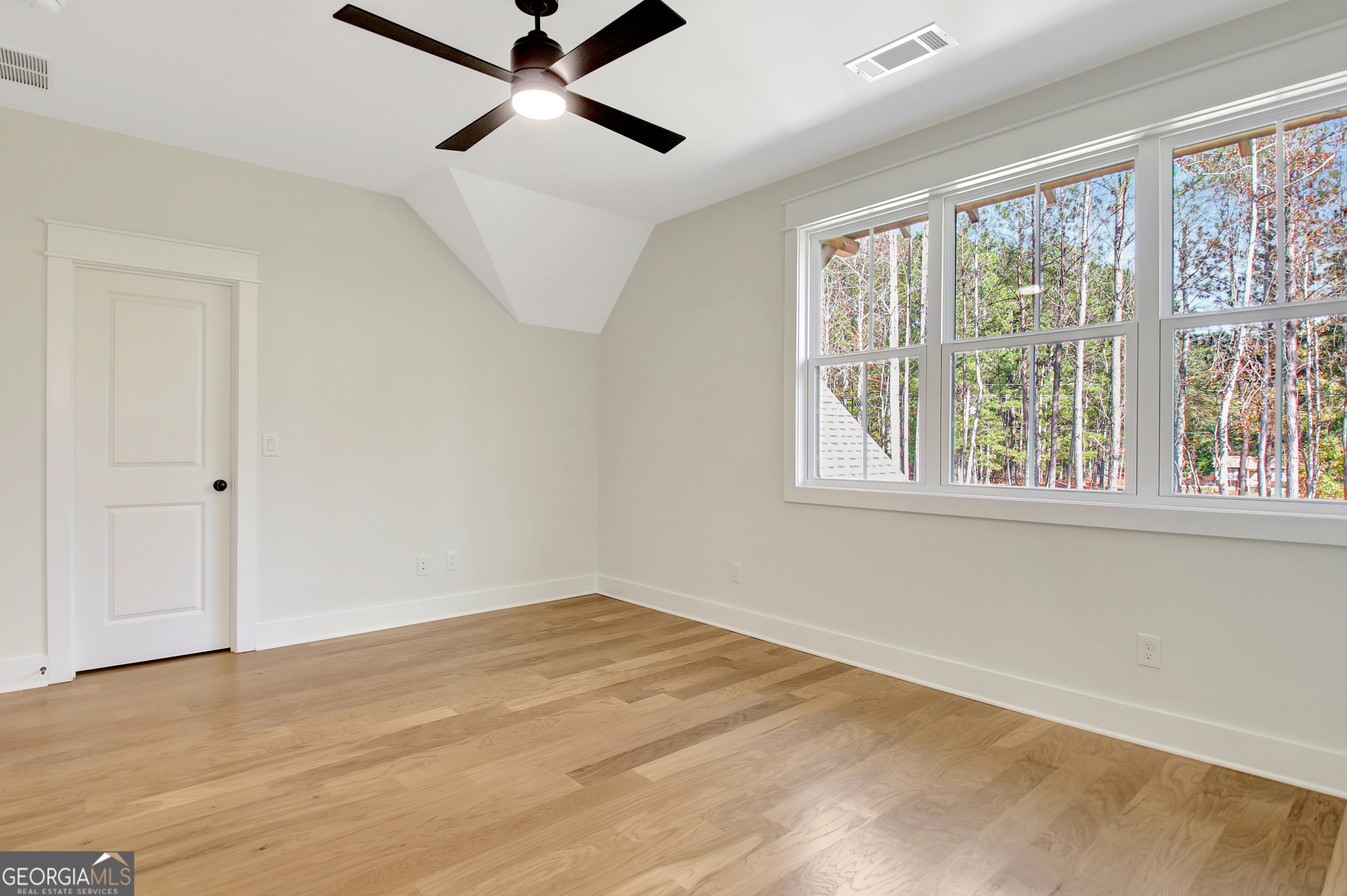 196 Bob Smith Road Sharpsburg, GA 30277 - Photo 59 of 68 a view of a big room with wooden floor and windows