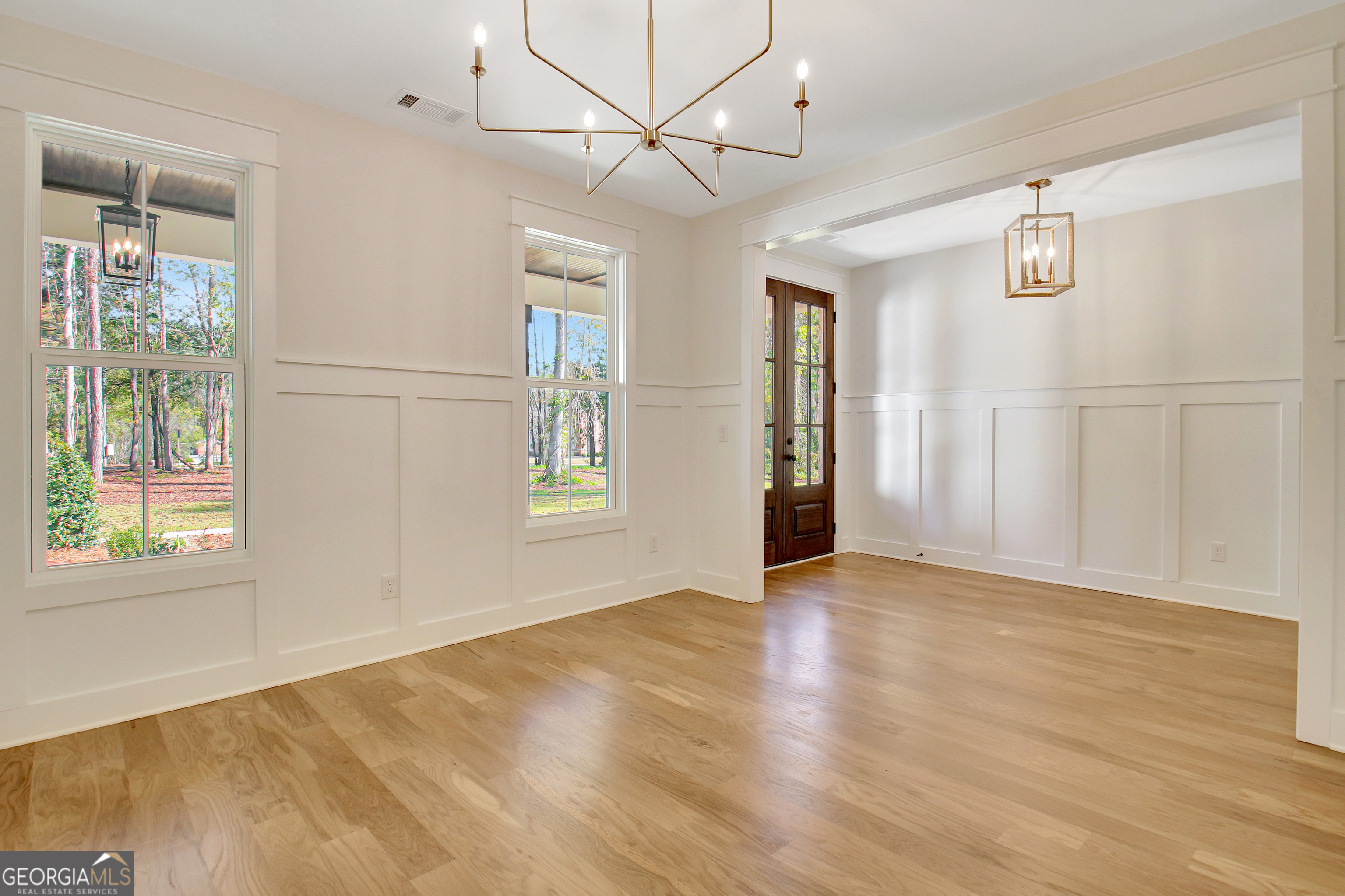 196 Bob Smith Road Sharpsburg, GA 30277 - Photo 10 of 68 a view of an empty room with a window and wooden floor