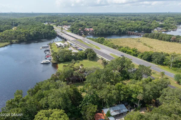 an aerial view of a house with a yard and lake view