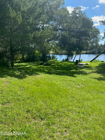 a view of yard with swimming pool and green space
