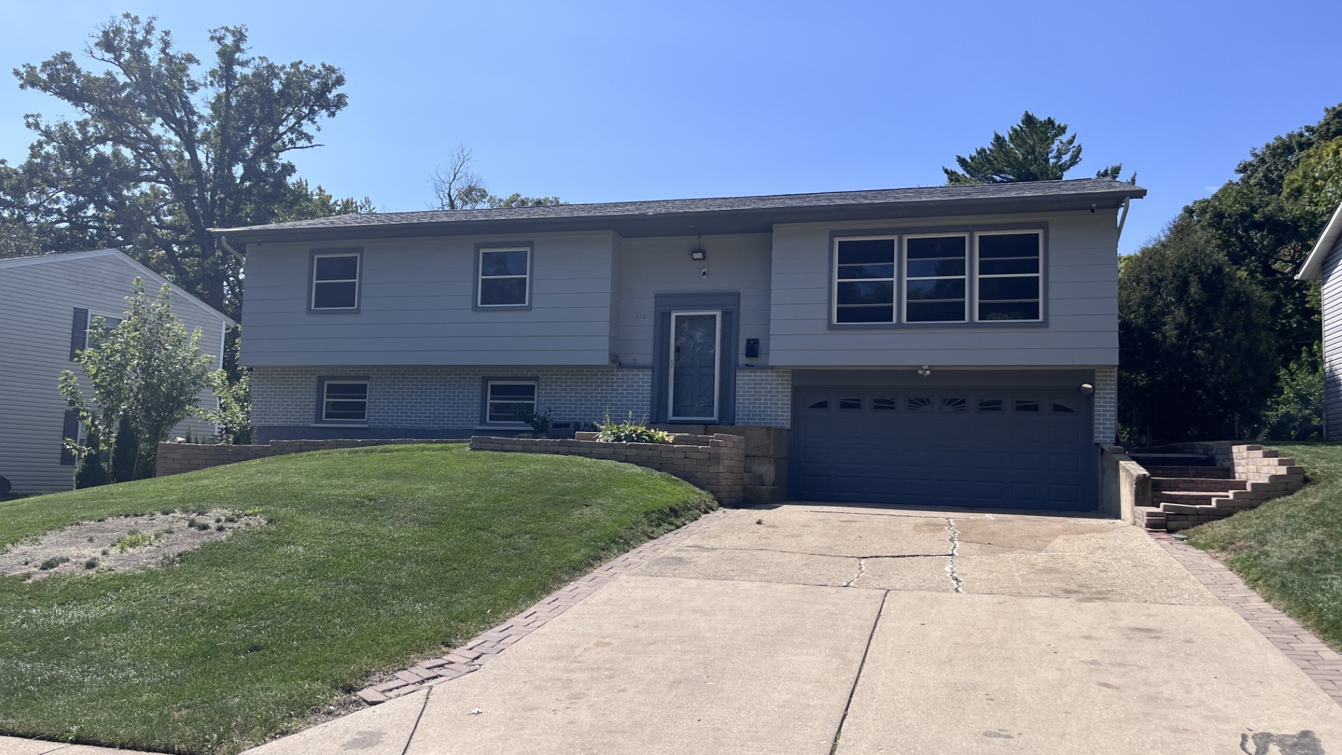 110 Woodcrest Circle Streamwood, IL 60107 - Photo 1 of 24 a front view of a house with a garden and yard
