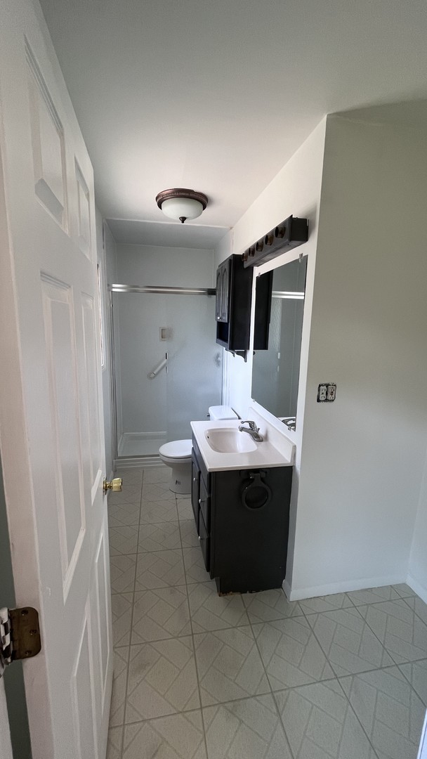 110 Woodcrest Circle Streamwood, IL 60107 - Photo 12 of 24 a room with a wooden floor and white wall