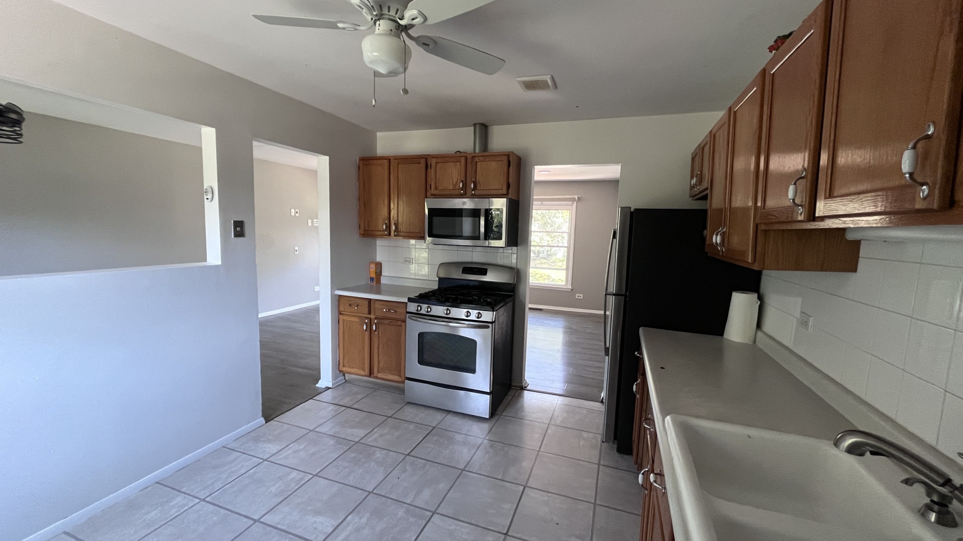110 Woodcrest Circle Streamwood, IL 60107 - Photo 2 of 24 a kitchen with granite countertop a refrigerator stove and microwave