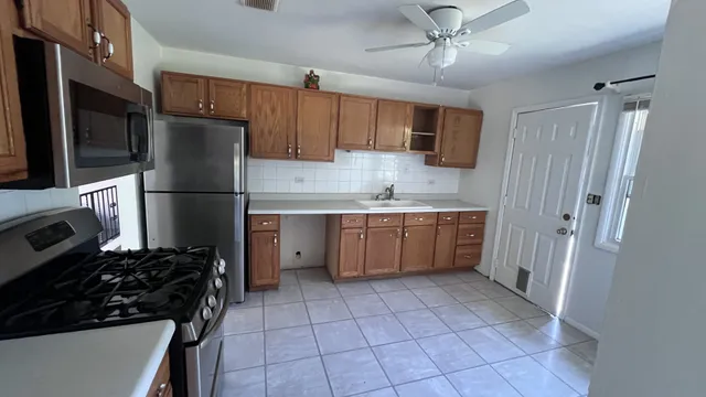a kitchen with a refrigerator a stove top oven a sink and dishwasher