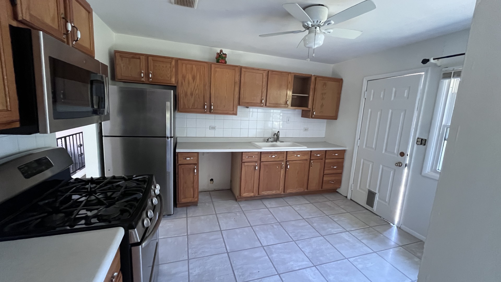 110 Woodcrest Circle Streamwood, IL 60107 - Photo 3 of 24 a kitchen with a refrigerator a stove top oven a sink and dishwasher