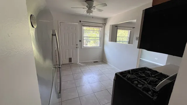 a kitchen with a stove a sink and a refrigerator