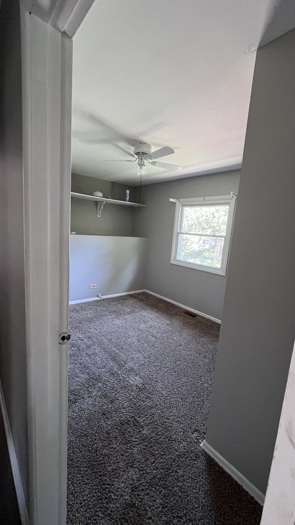110 Woodcrest Circle Streamwood, IL 60107 - Photo 9 of 24 a view of an empty room with a window