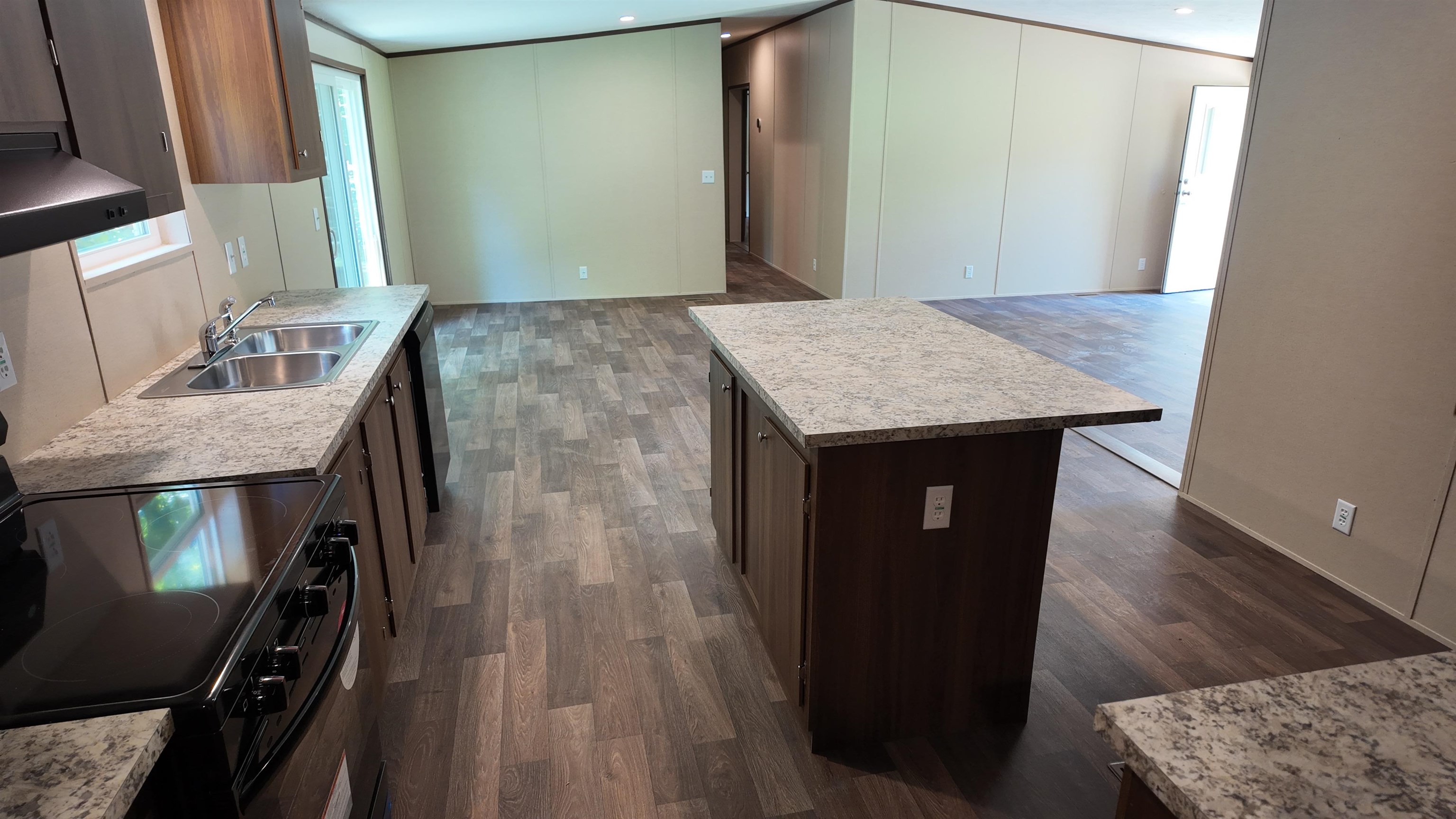 208 Marcy Cove Ripley, TN 38063 - Photo 14 of 14 Kitchen with black electric range oven, open floor plan, and light countertops
