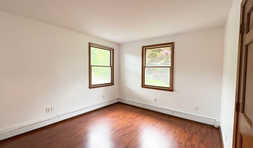 2 Robert Cohen Drive Canton, MA 02021 - Photo 12 of 26 an empty room with wooden floor and windows