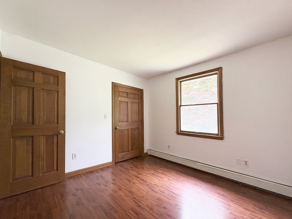 2 Robert Cohen Drive Canton, MA 02021 - Photo 14 of 26 an empty room with wooden floor and windows